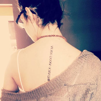 The roman numerals on her shoulder  A Guide To Rihannas Tattoos Her  25  Capital XTRA